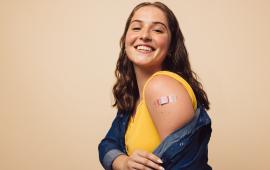 Girl showing arm after getting vaccinated