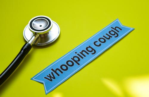 Doctor's stethoscope next to the word "Whooping Cough." 