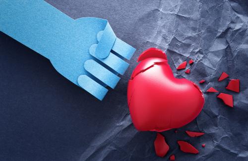 Abstract image depicting Domestic Violence. Broken heart beating by a paper fist.