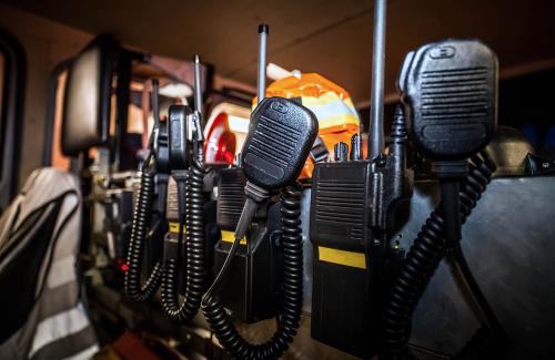 Several emergency radios hanging in a row
