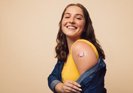 Girl showing arm after getting vaccinated