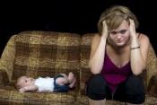 Anxious mom with baby on couch