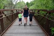 Amber and boys walking on bridge