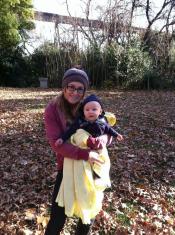 Elisa and baby outside in Fall, leaves on the ground