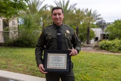 Deputy Austin Nelson holds a plaque