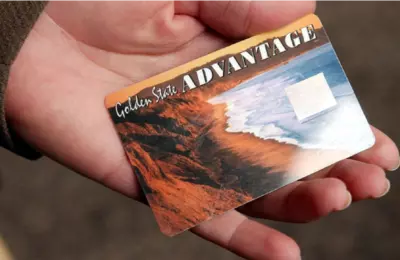 Hand holding a California EBT card